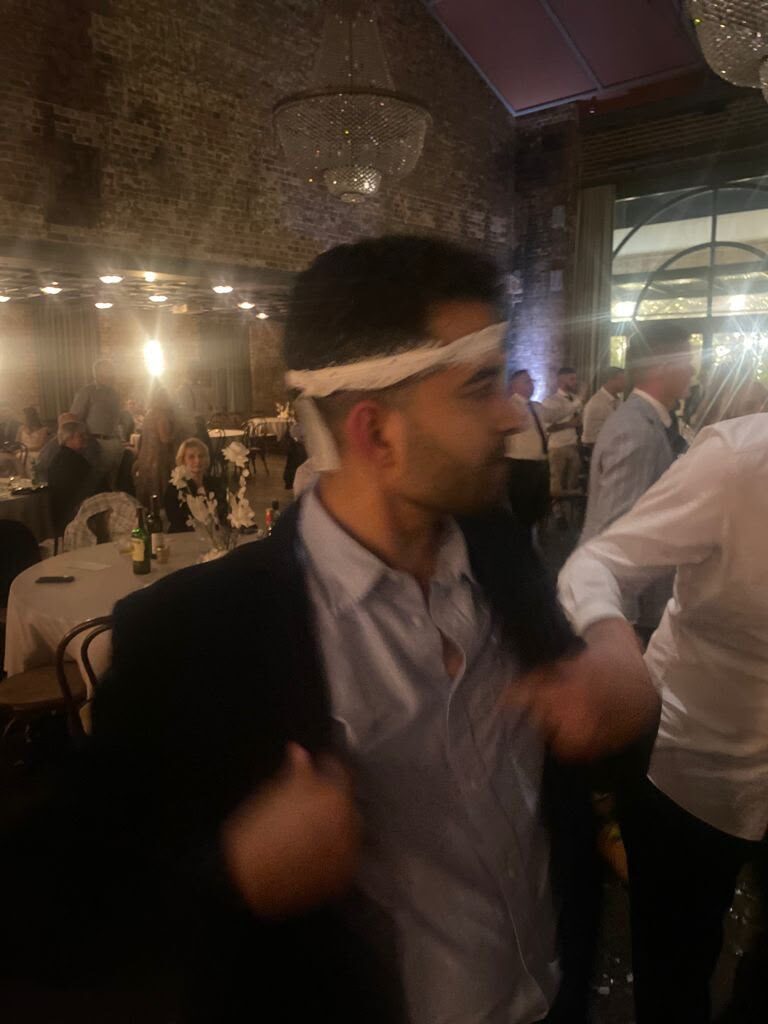 Mayuresh at a wedding reception with a napkin tied around his head